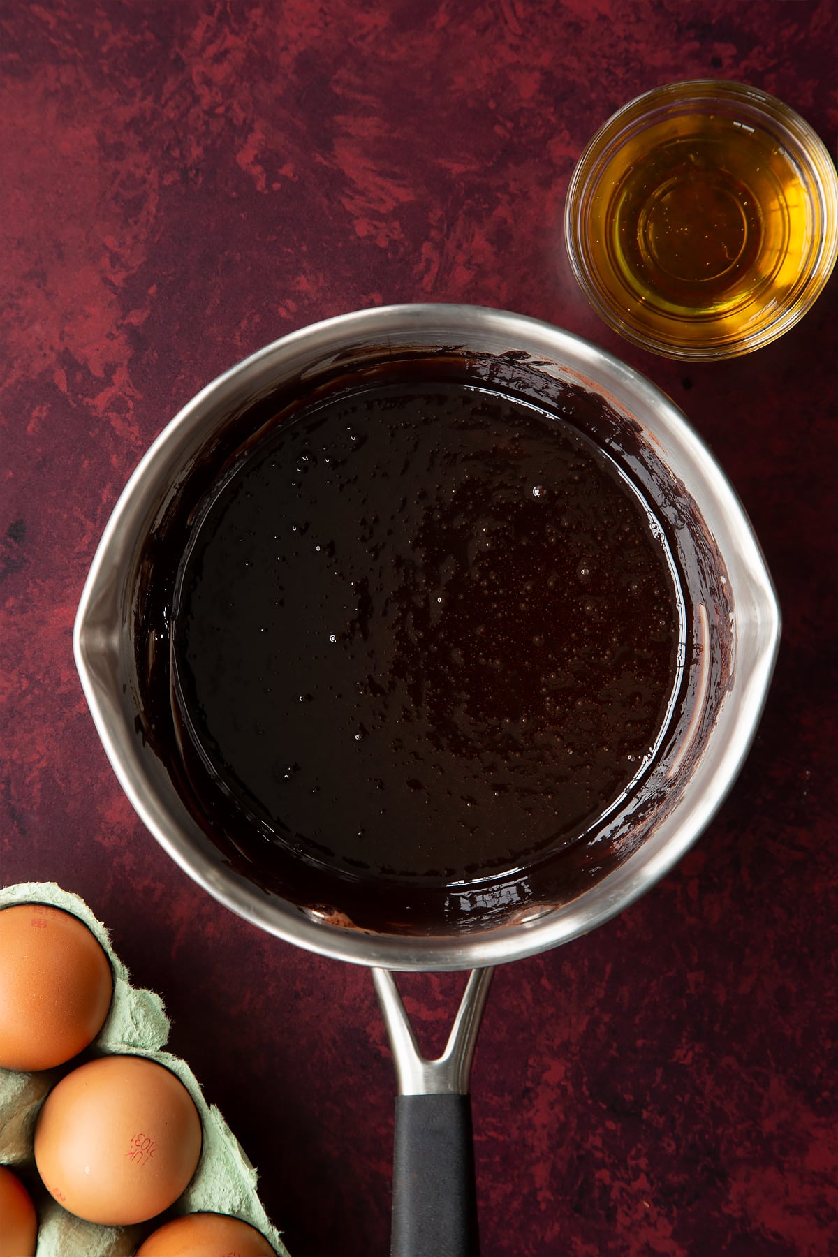 Chocolate drizzle syrup in a small saucepan.