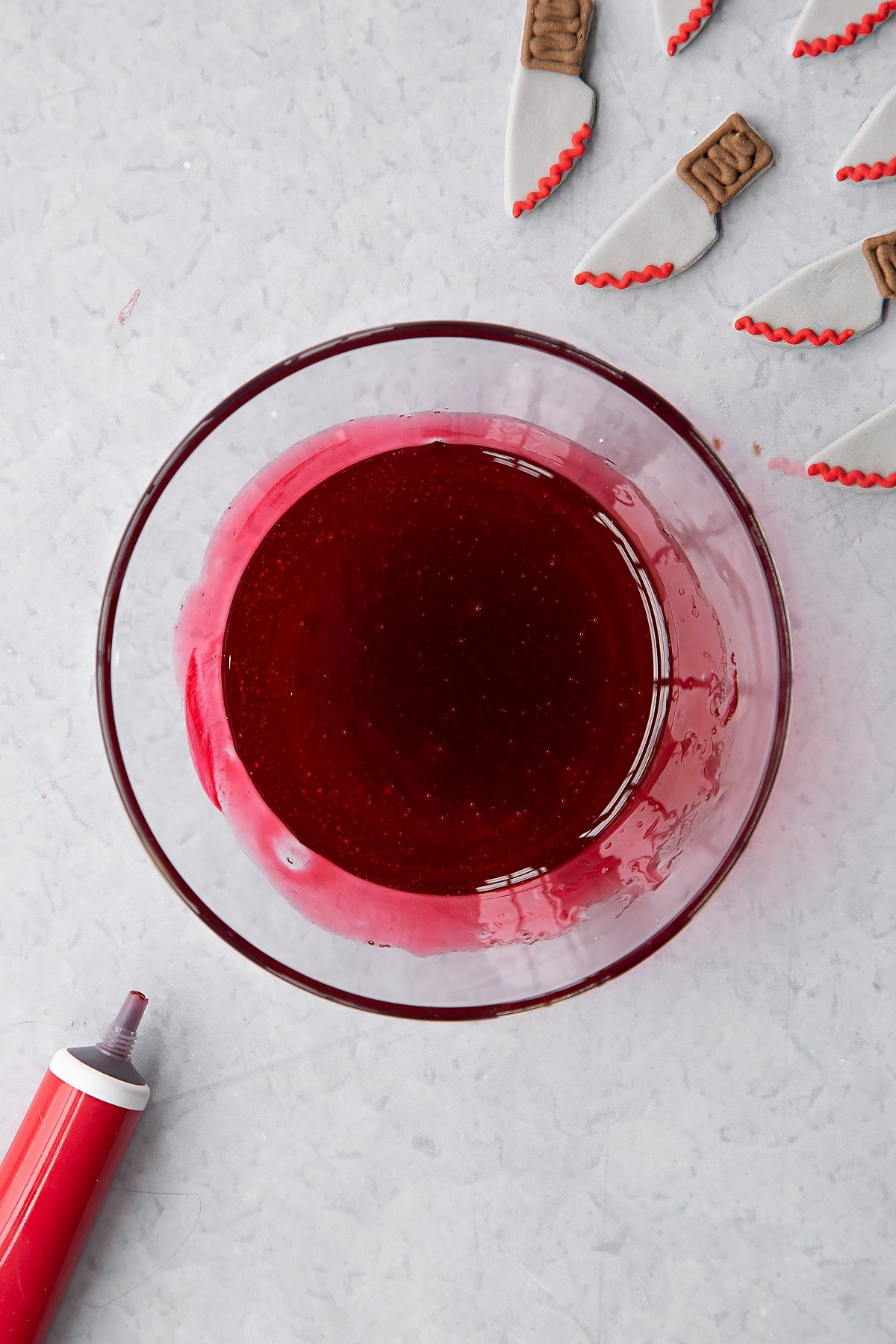 Golden syrup dyed red in a small bowl.