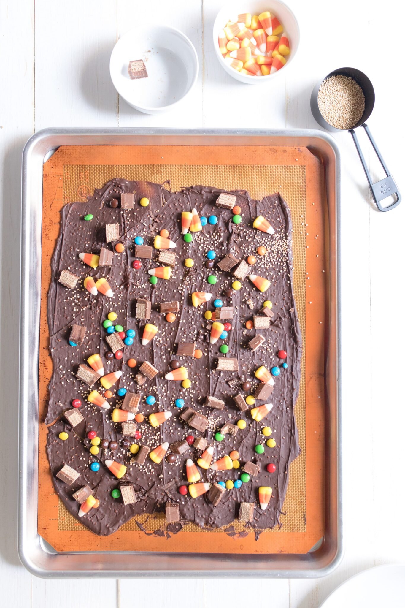 Dark chocolate Halloween bark decorated with Halloween candy.