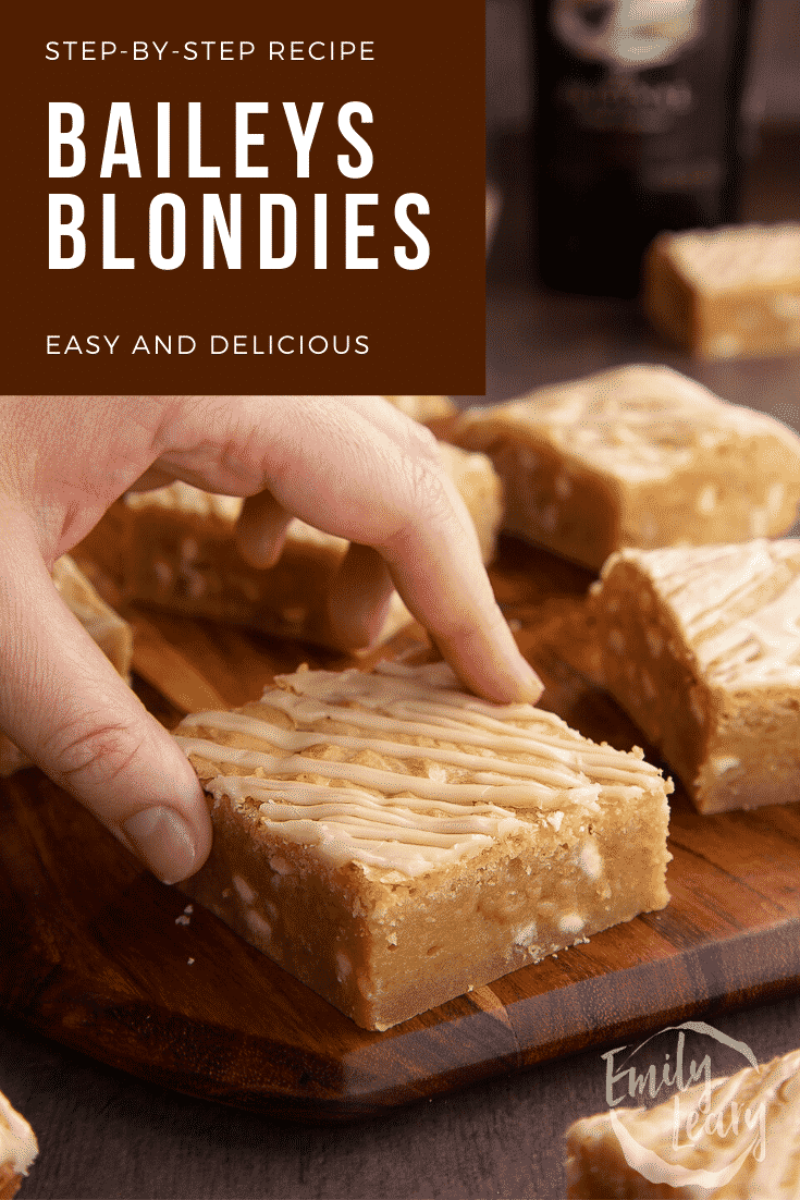 Baileys blondie on a wooden board. A hand reaches for it. Caption reads: Step-by-step recipe. Baileys blondies. Easy and delicious.