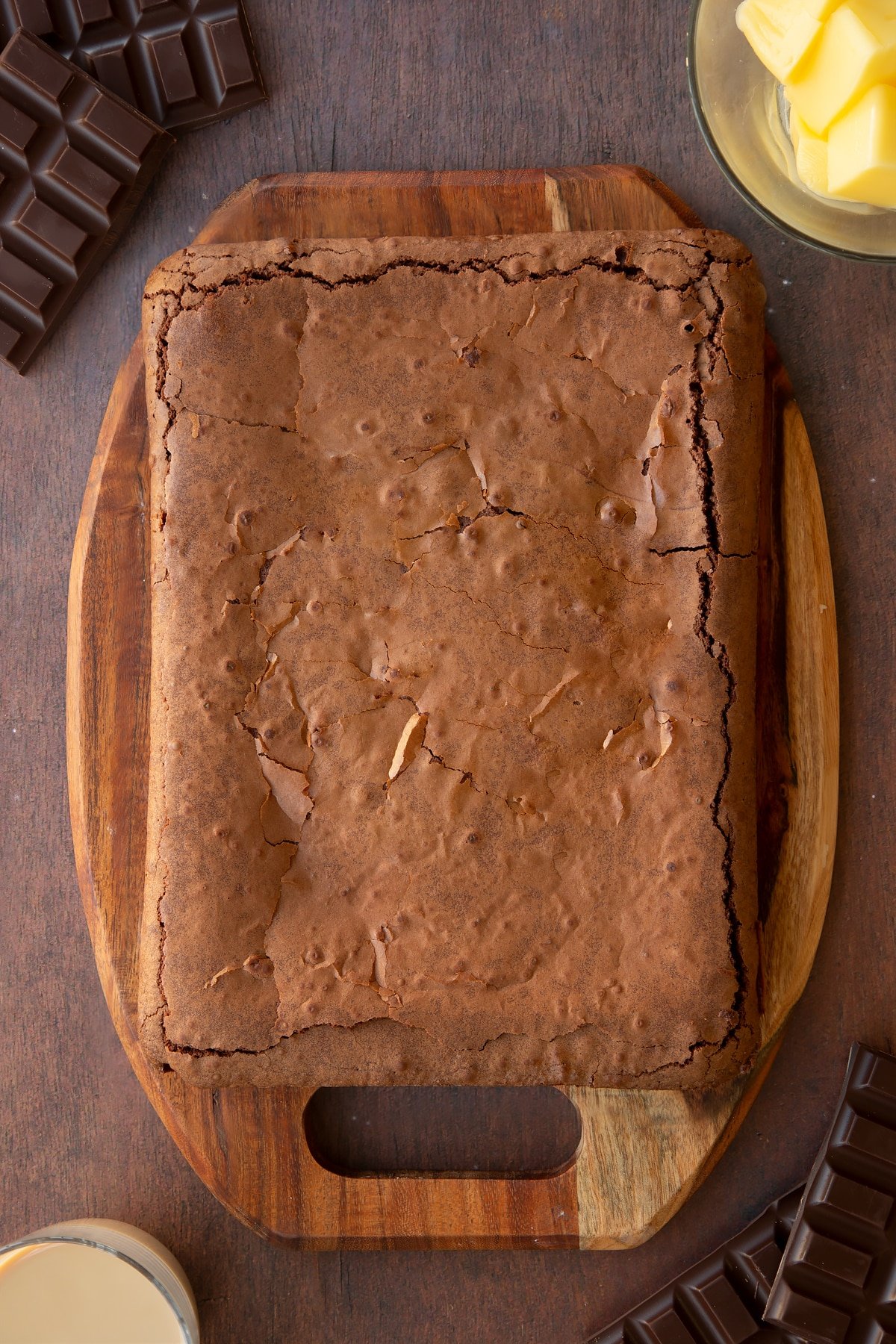 Freshly baked Baileys brownie on a board.