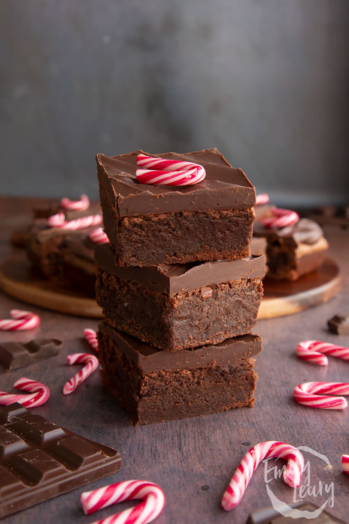 Three candy cane brownies stacked with more in the background. 