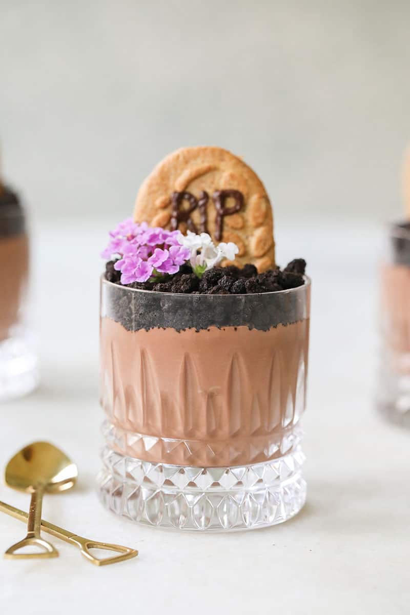 Halloween dirt cups - chocolate pudding topped with chocolate soil and a cookie gravestone.