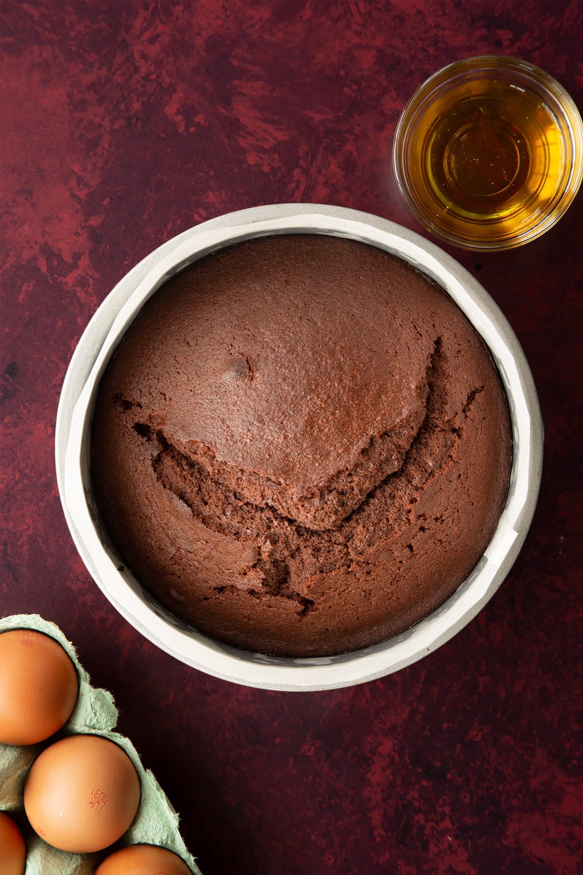 Baked chocolate drizzle cake in a lined tin. 