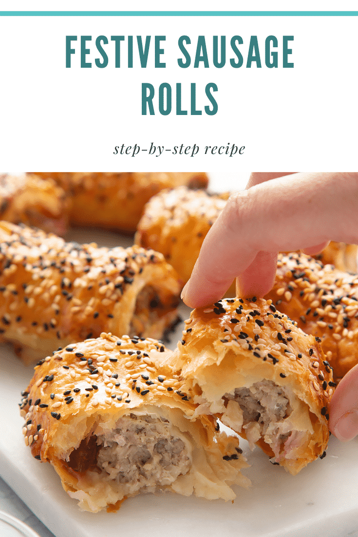 A festive sausage roll broken open on a white marble board. A hand reaches for it. Caption reads: Christmas sausage rolls. Step-by-step recipe.