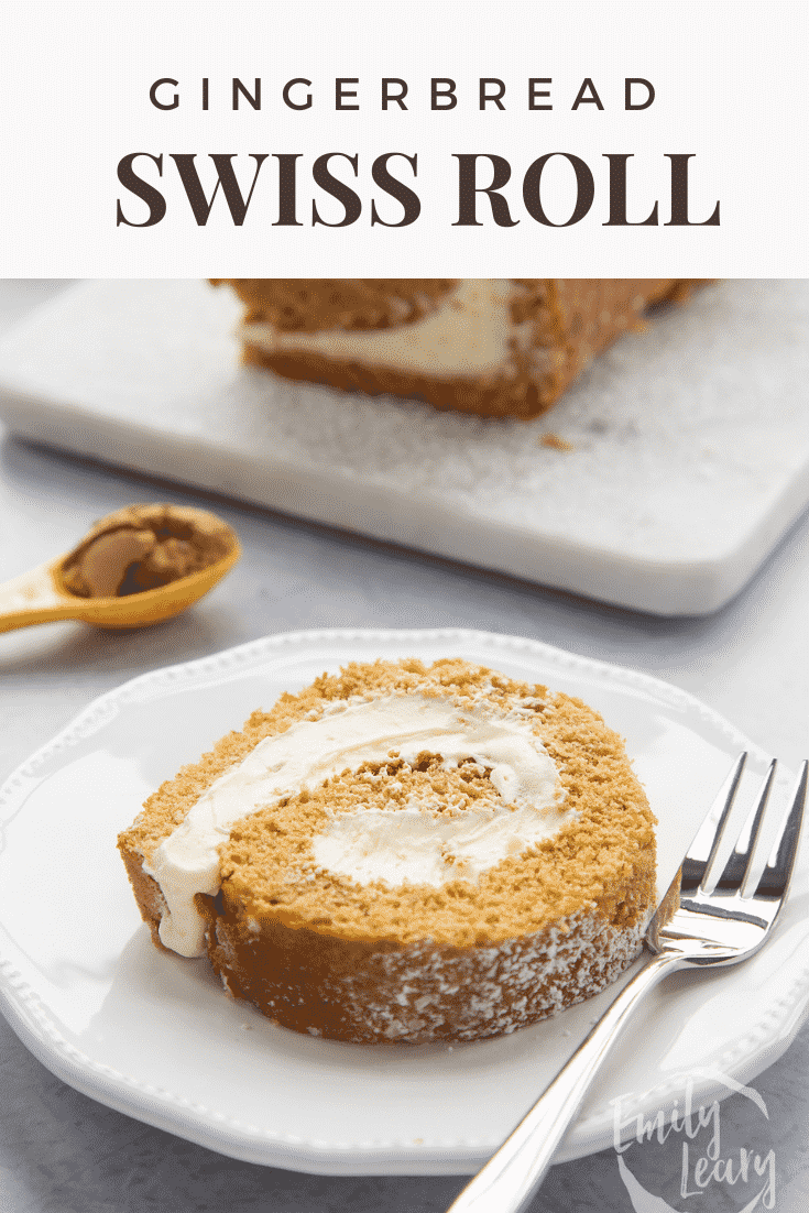 A slice of gingerbread Swiss roll on a white plate with a fork. Caption reads: Gingerbread Swiss roll. 