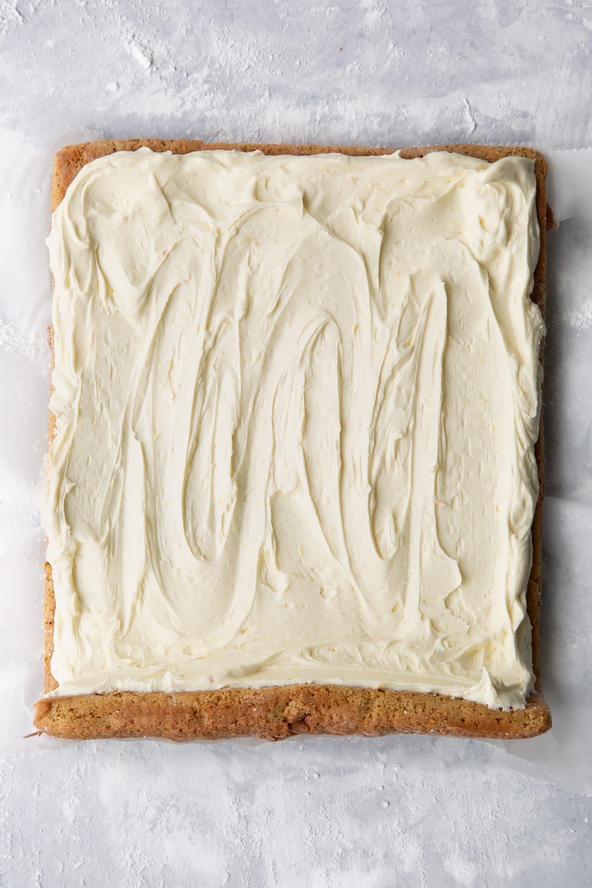 Gingerbread Swiss roll sponge unrolled and spread with lemon white chocolate buttercream.