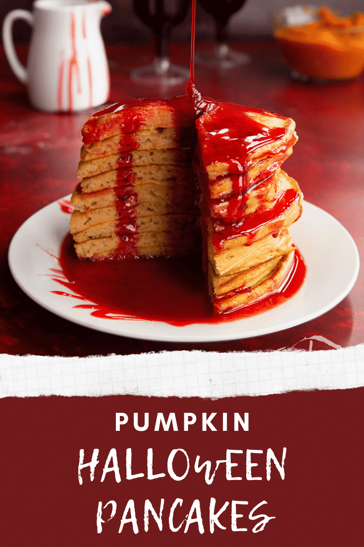 Halloween pancakes stacked on a white plate, drizzled with red syrup and a slice cut out. Caption reads: Pumpkin Halloween pancakes. 