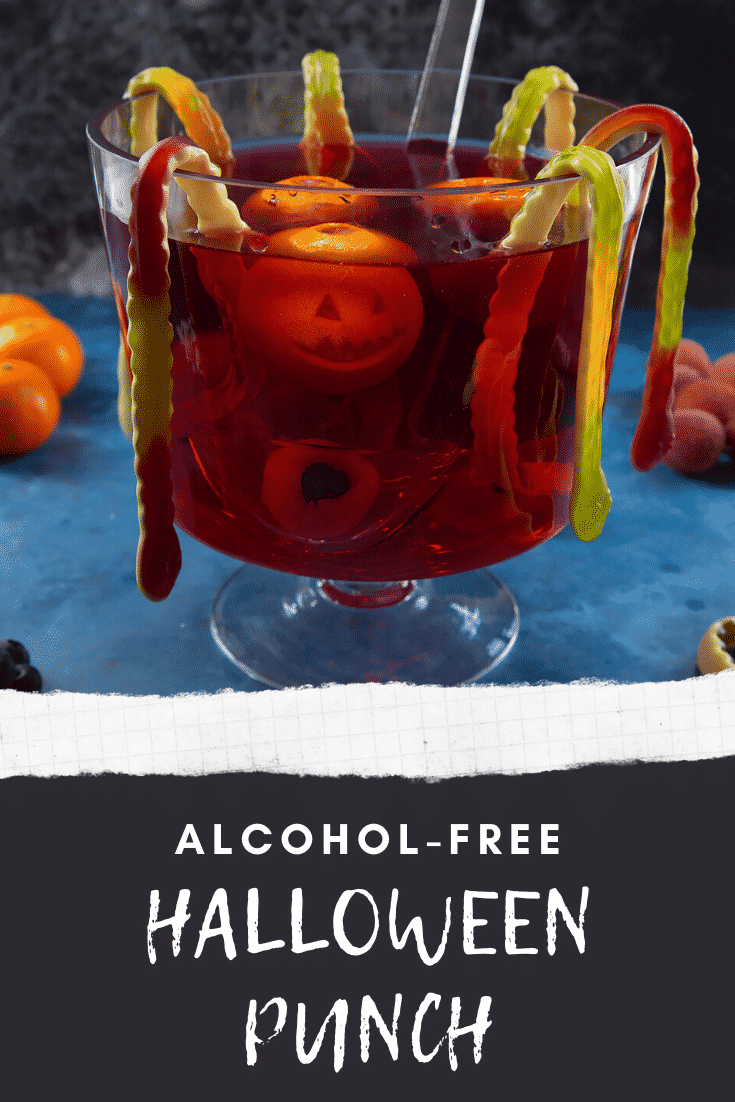 Halloween punch, decorated with fruit and gummy snakes. Caption reads: Alcohol free Halloween punch.