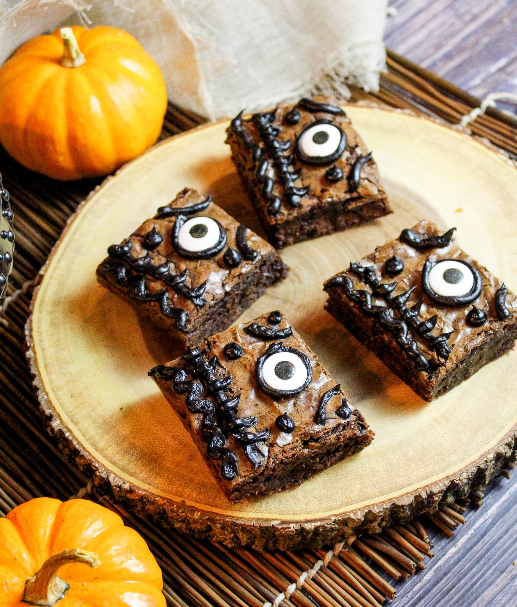 Brownies on a wooden board. They have been decorated to look like Hocus Pocus spell books.