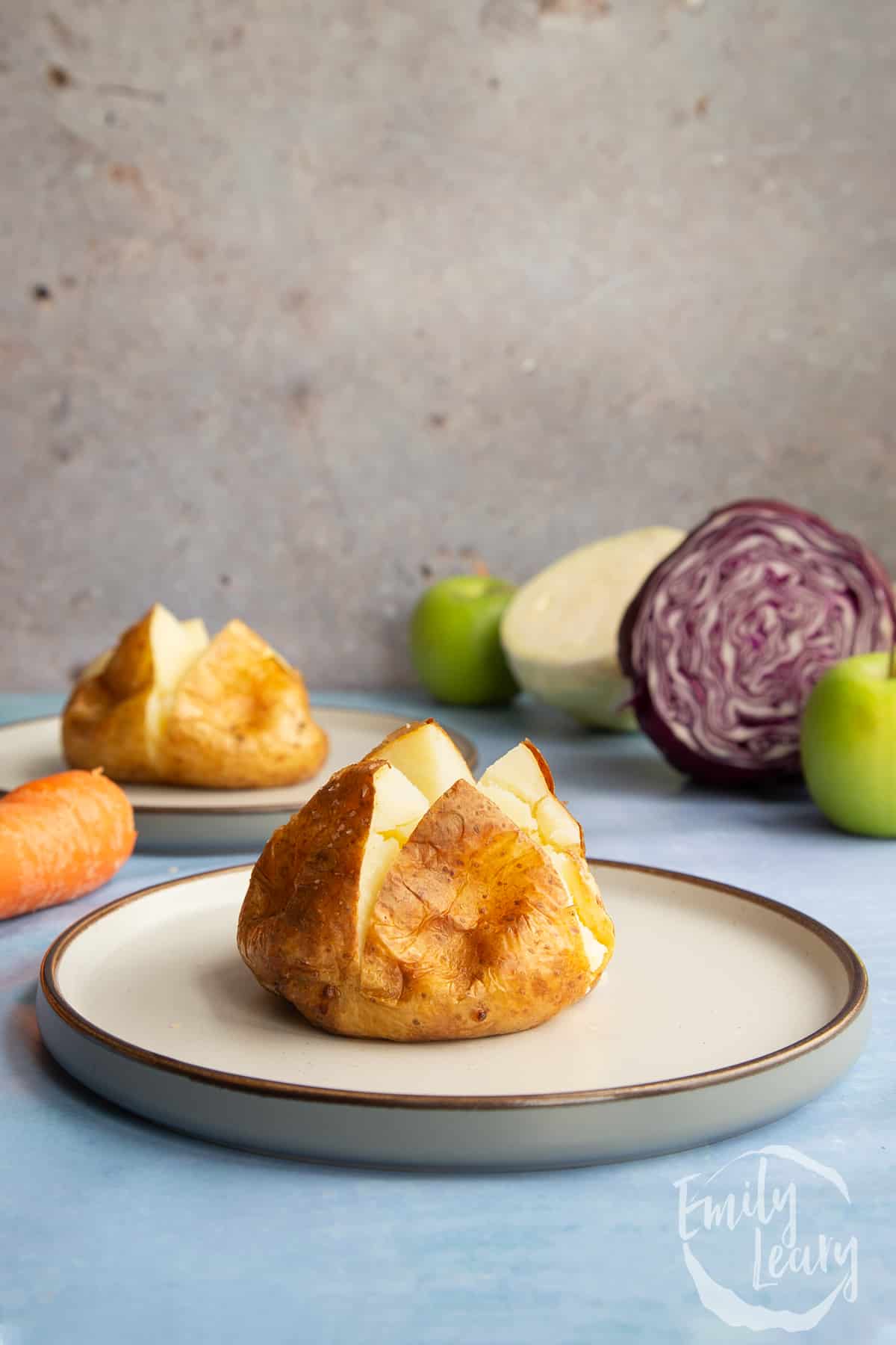 A jacket potato cut open on a plate.