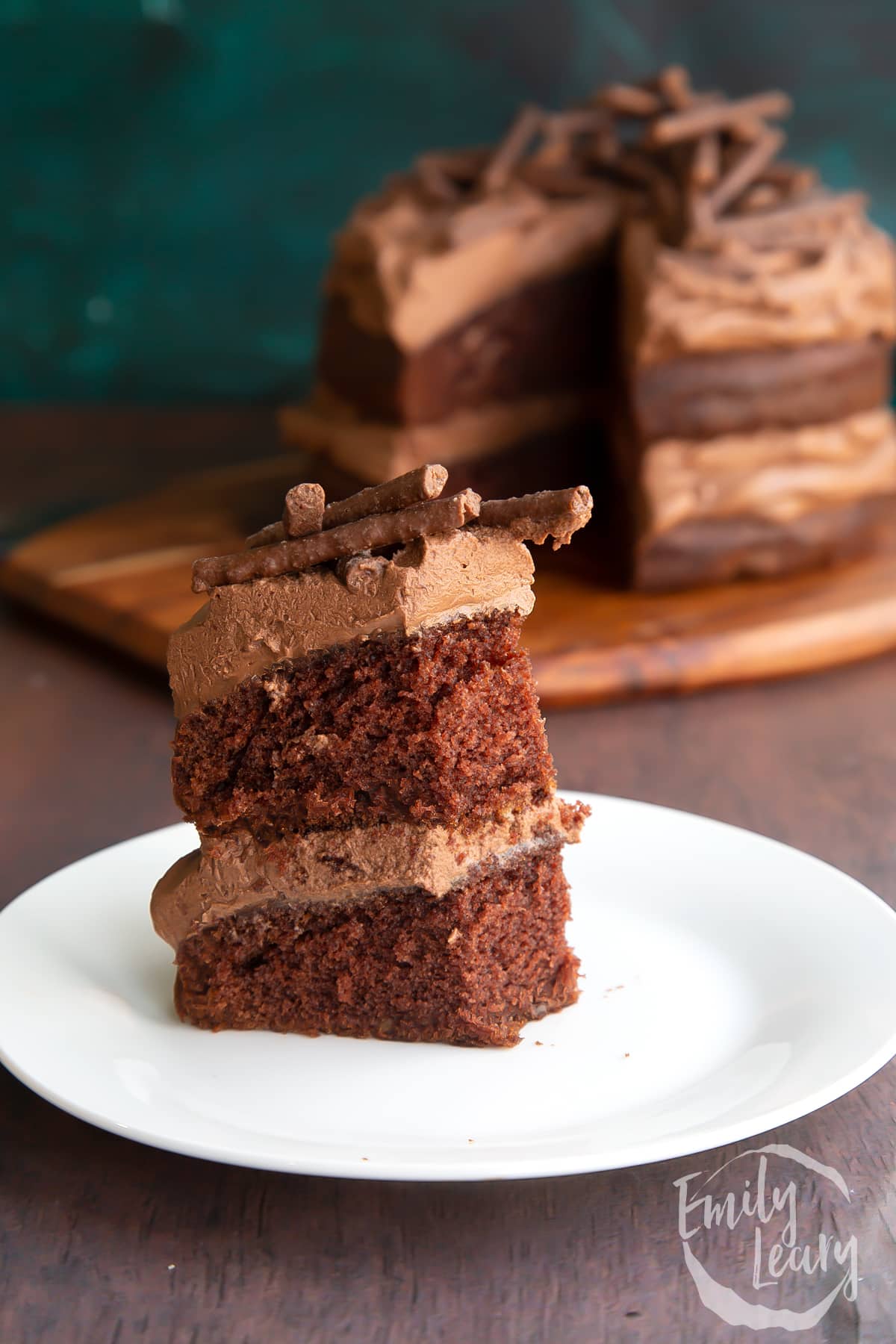 Slice of mint chocolate Matchmaker cake on a white plate. Some of the slice has been taken.