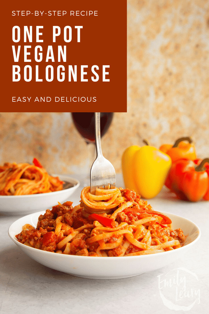 One pot vegan bolognese in a shallow white bowl. A hand delves a fork into the bowl. Caption reads: Step-by-step recipe one pot vegan bolognese. Easy and delicious