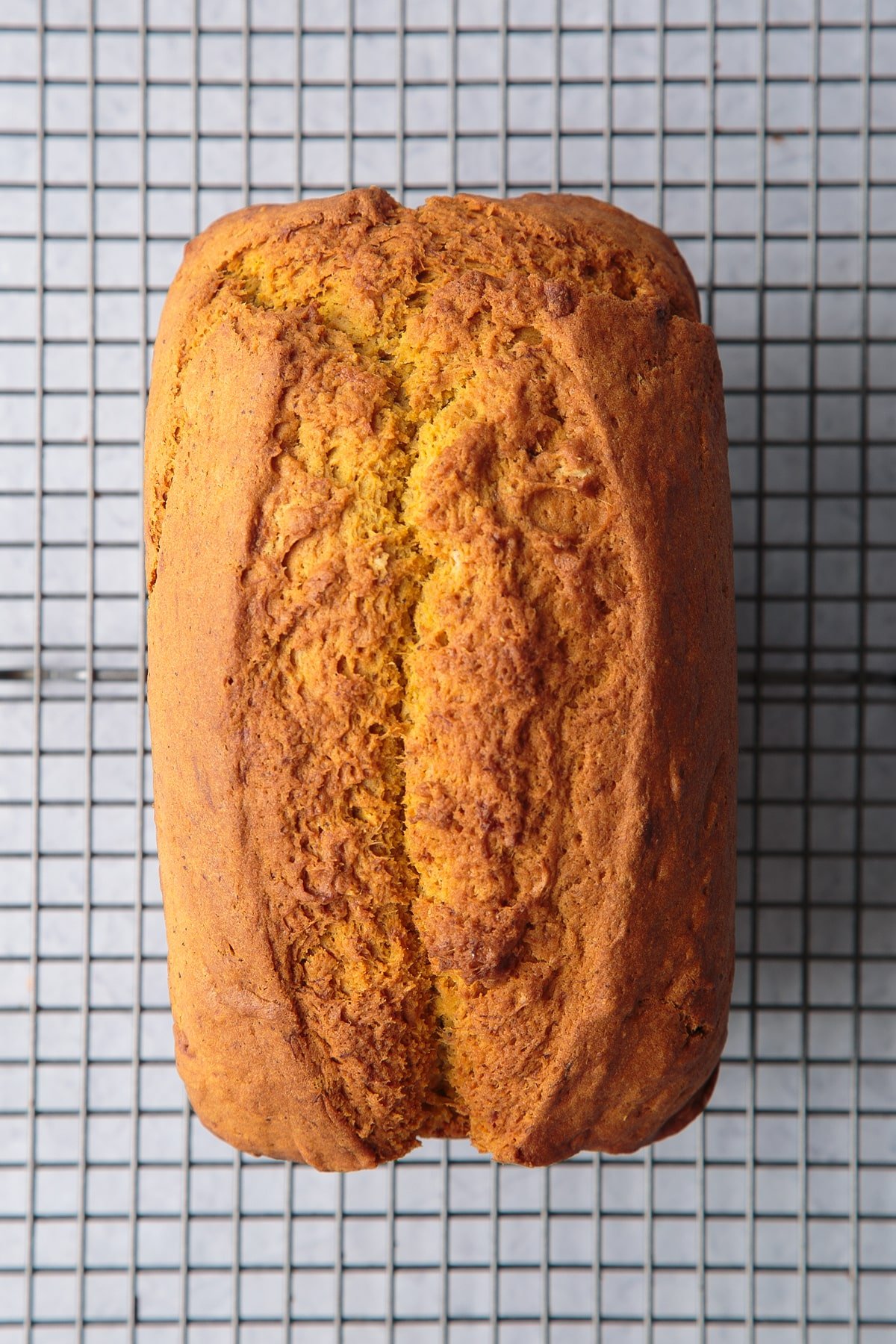 Pumpkin banana bread loaf cooling on a wire rack.