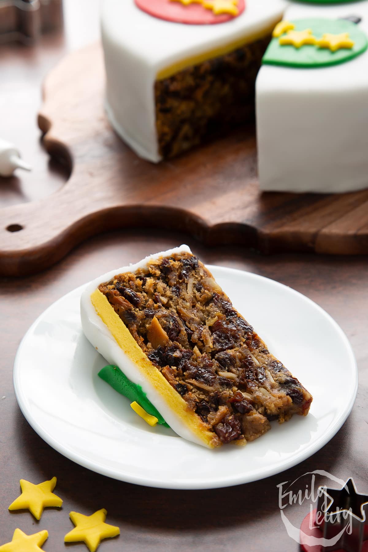 Slice of vegan Christmas cake on a white plate. 