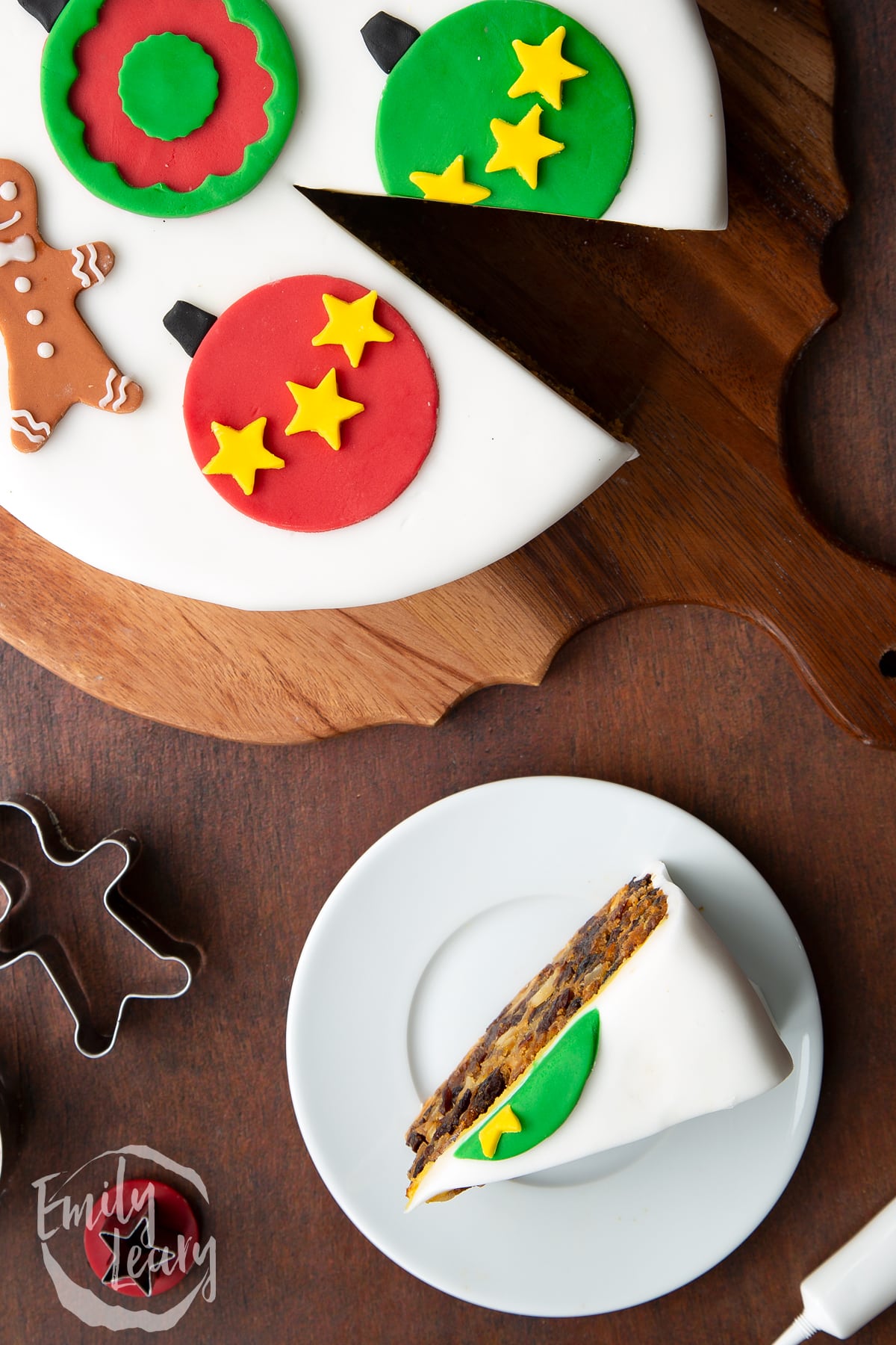 Slice of vegan Christmas cake standing on a white plate. Shown from above.