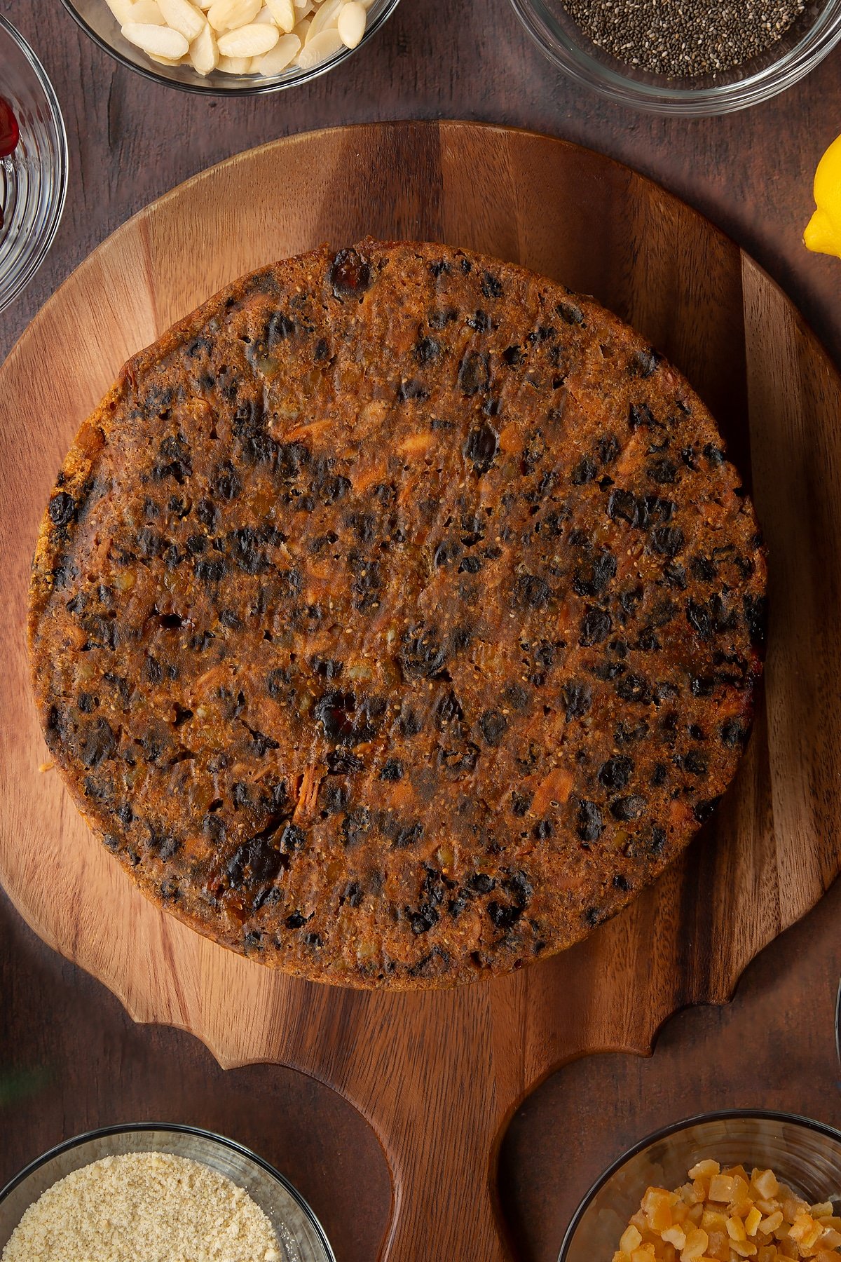 Vegan Christmas cake, upside down on a wooden board.