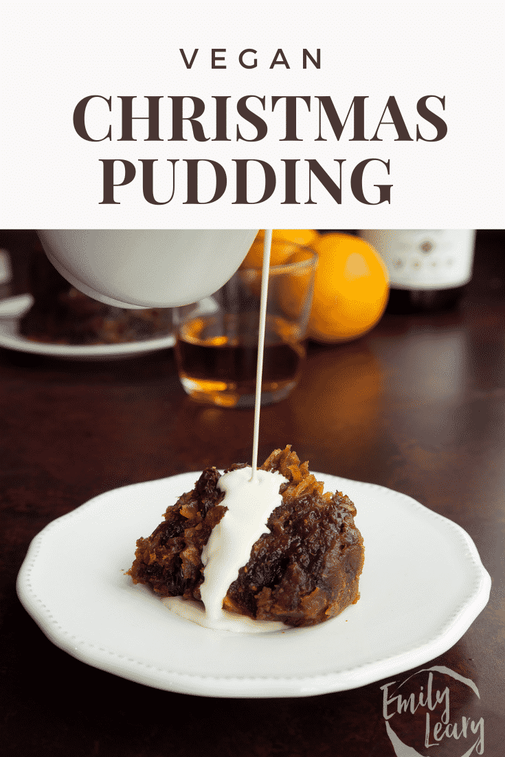 A piece of vegan Christmas pudding on a white plate with cream. Caption reads: vegan Christmas pudding