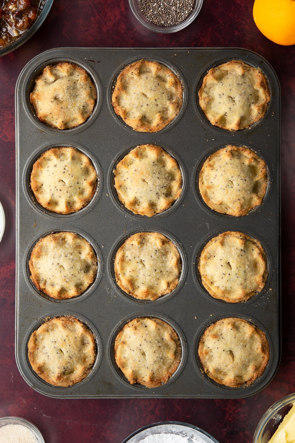 Freshly baked vegan mince pies in a muffin tray.