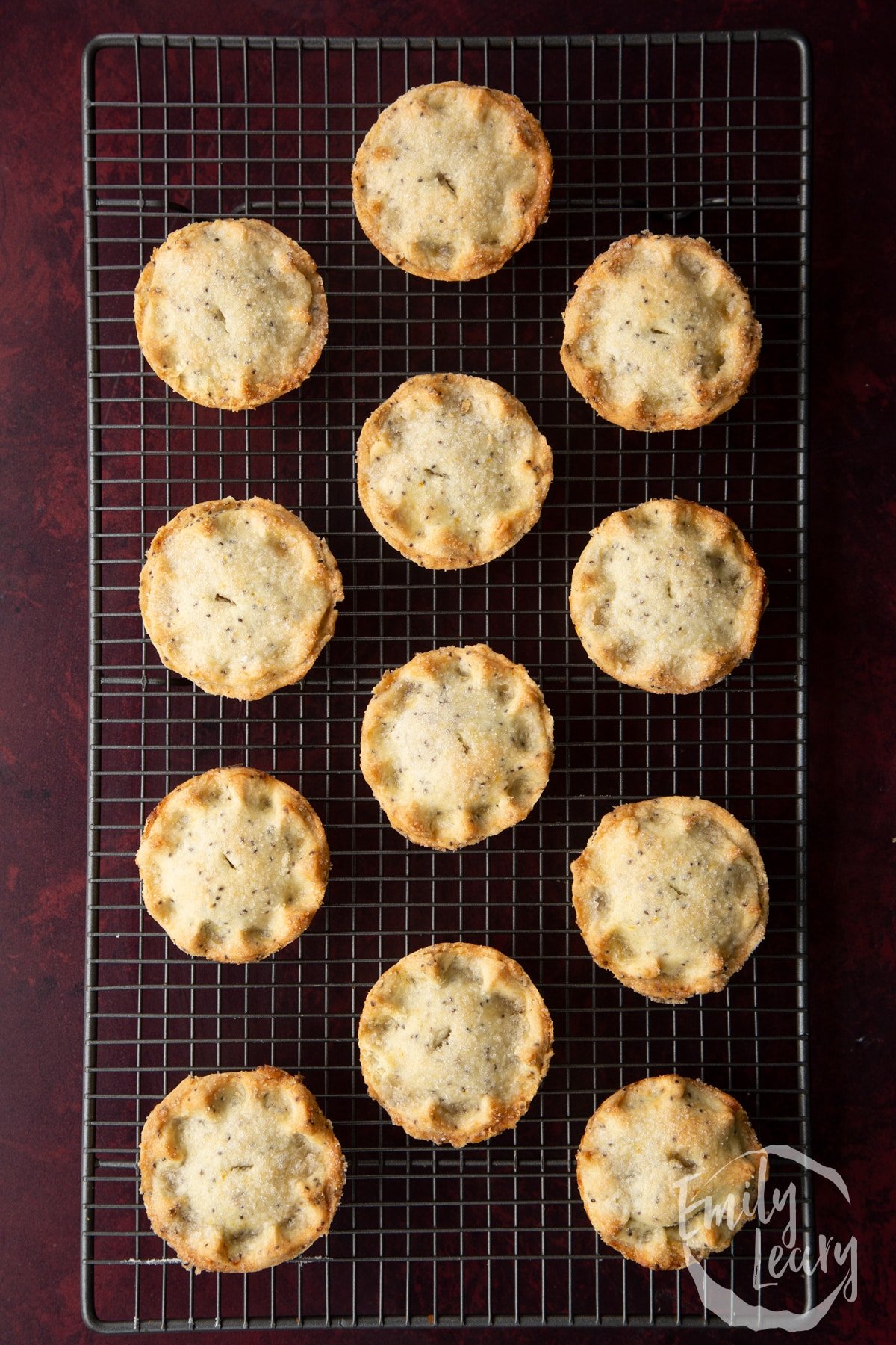 Freshly baked vegan mince pies on a wire cooling rack.