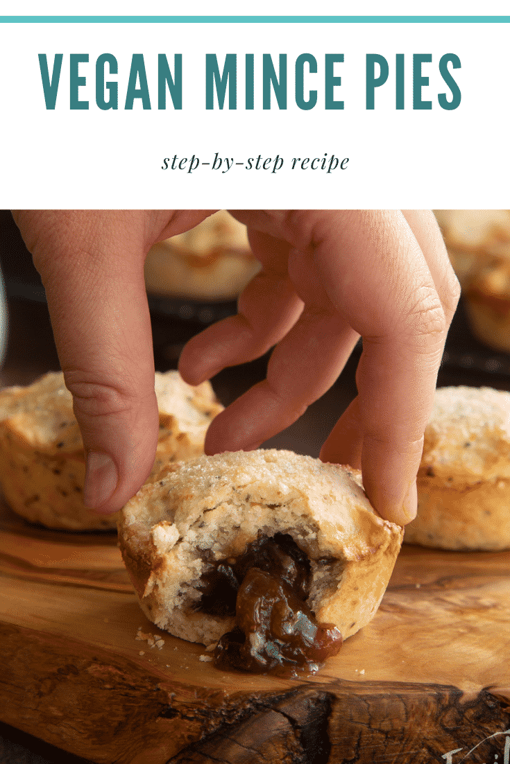 Vegan mince pies on a olive board with more on a wire rack in the background. One has been bitten open and a hand reaches for it. Captions reads: Perfect vegan mince pies. Step-by-step recipe