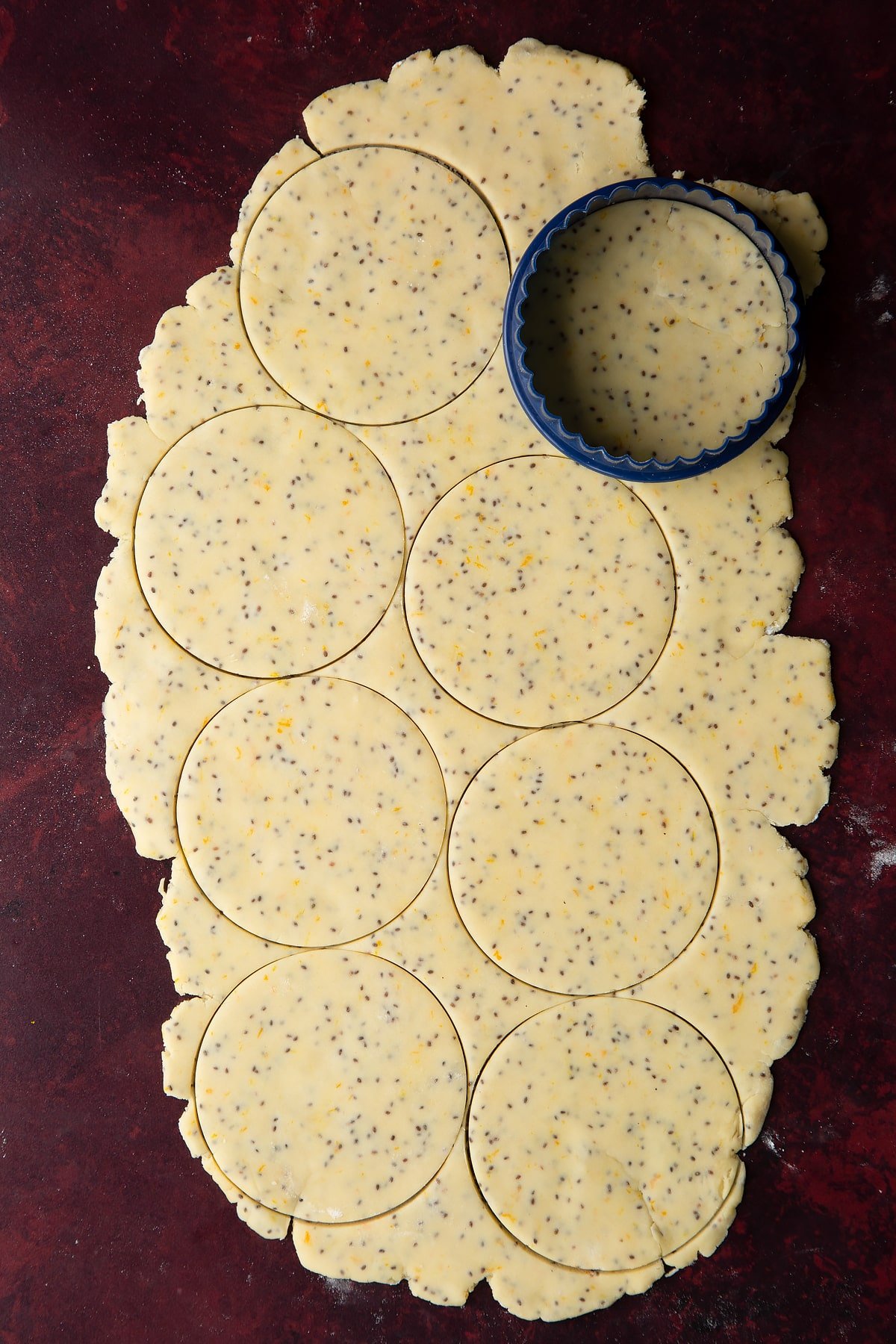 Vegan pastry rolled out thinly, with large discs cut out.