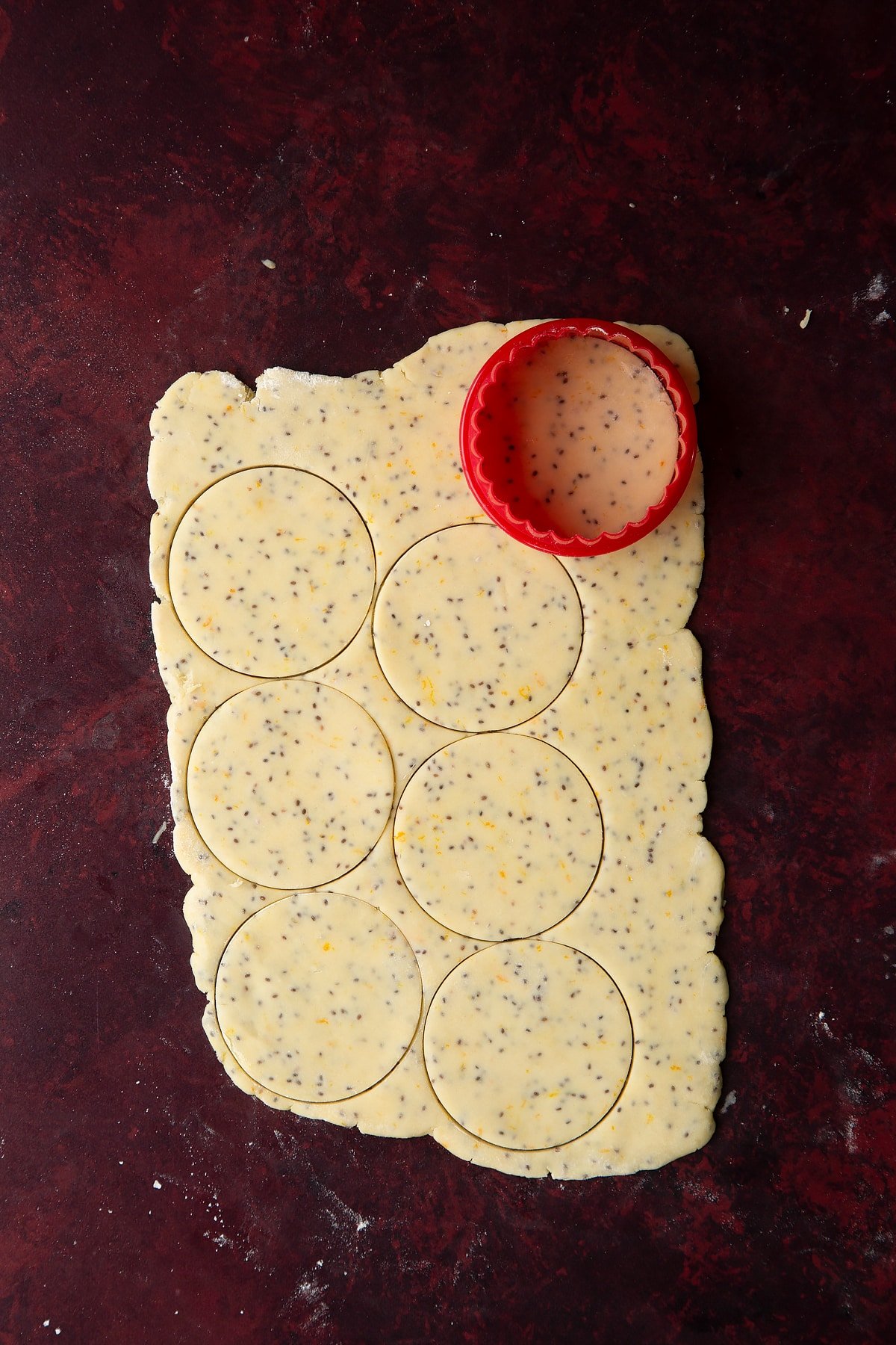 Vegan pastry rolled out thinly, with small discs cut out.