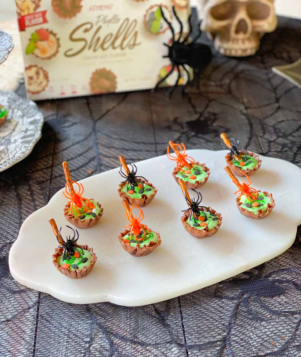 Witch's cauldrons made with phyllo filled with Halloween candy decorations.