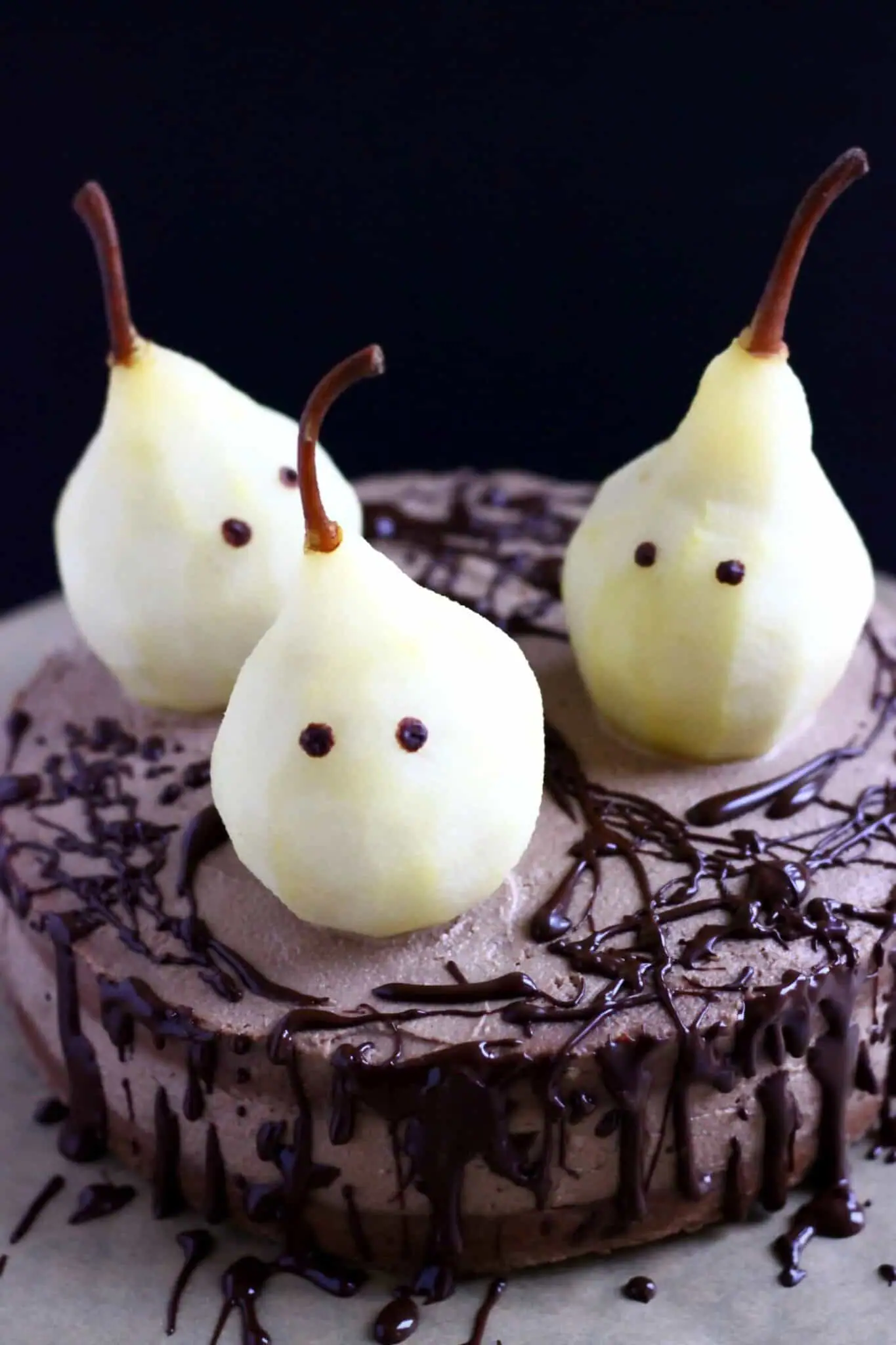 Gluten-free, vegan Halloween ghost cake, decorated with pears.