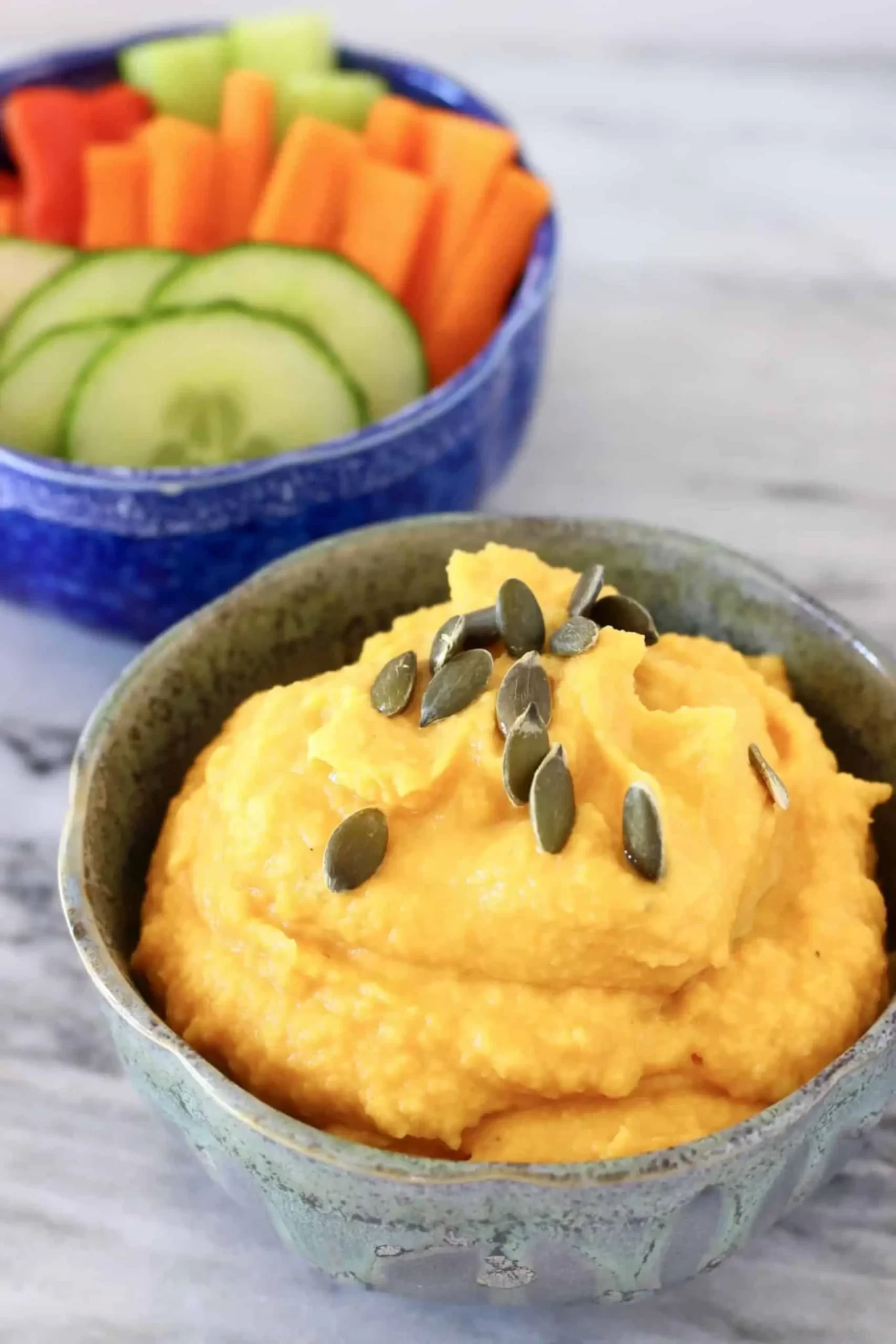 Pumpkin hummus served to a small bowl and garnished with pumpkin seeds