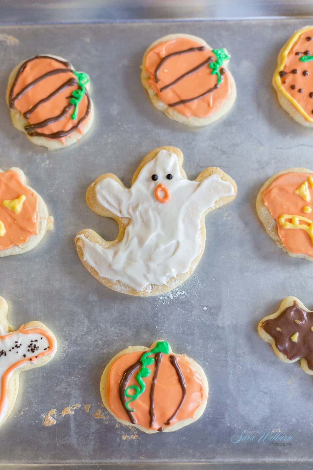 Halloween sour cream sugar cookies on a baking sheet.