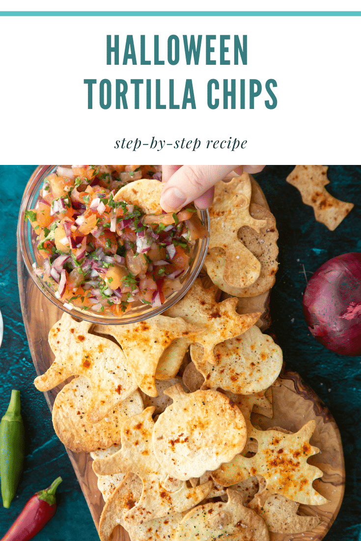 Halloween tortillas on a board with a small bowl of tomato salsa. A hand dips half a chip. Caption: Halloween tortilla chips. Step-by-step recipe.