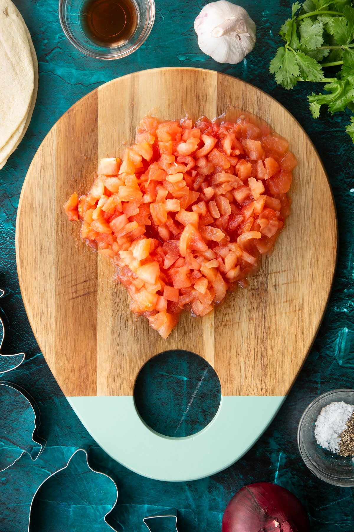 Chopped tomatoes on a wooden board.