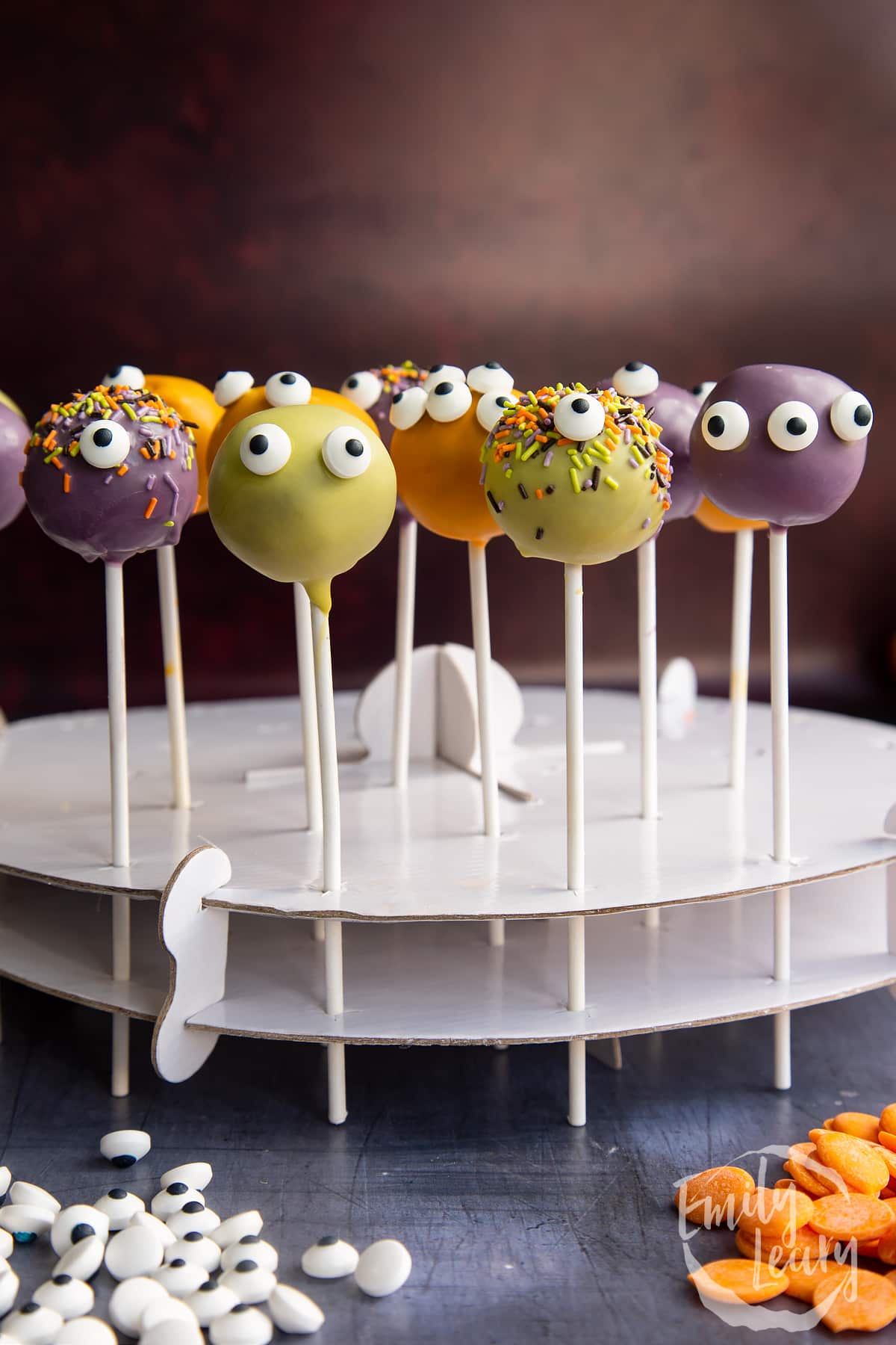 Halloween cake pops standing in white cardboard.