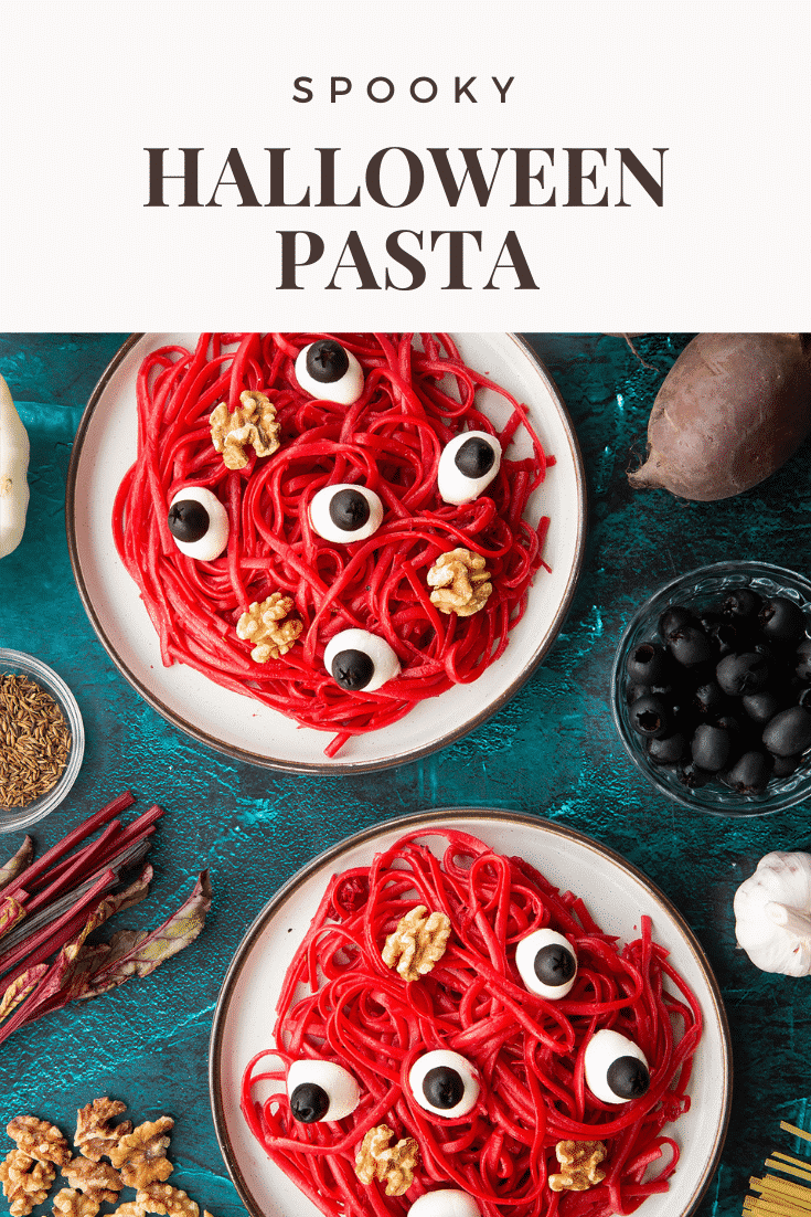 Two plates with a beetroot Halloween pasta recipe, topped with mozzarella eyes and walnut brains. Caption reads: Spooky Halloween Pasta.