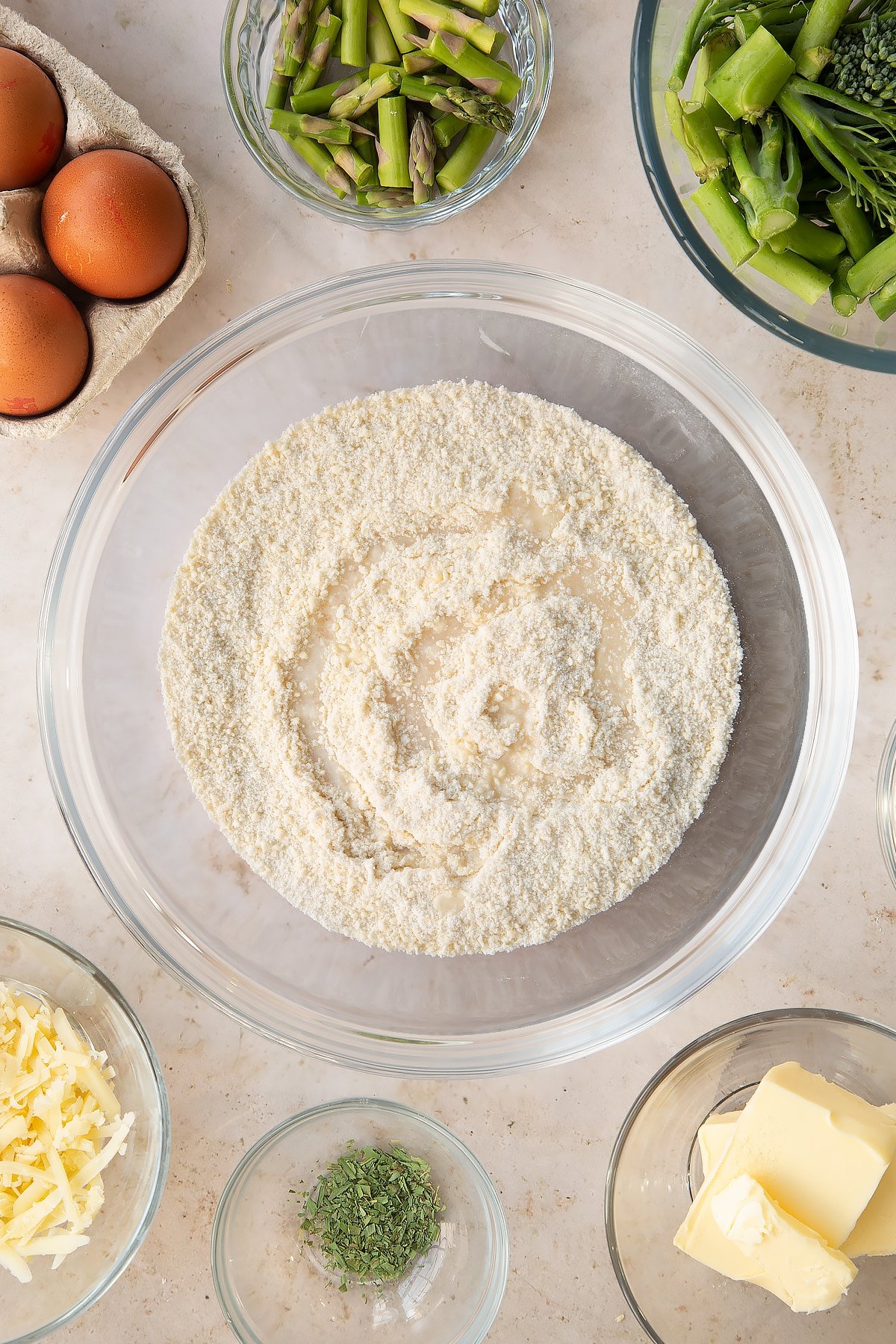 Overhead shot of the butter and flour mixed in a bowl with some water.