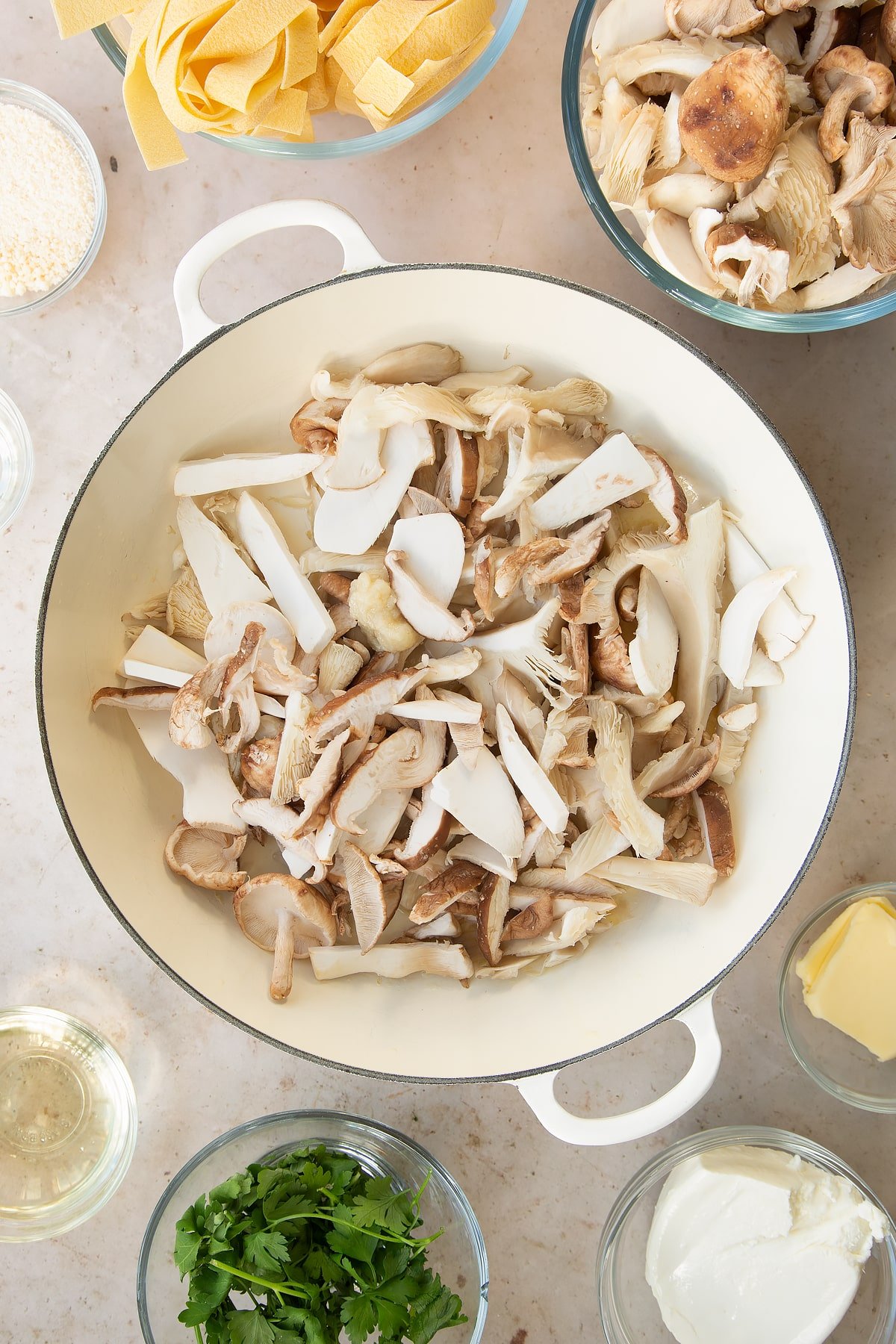 uncooked garlic and mushrooms in a large pan.