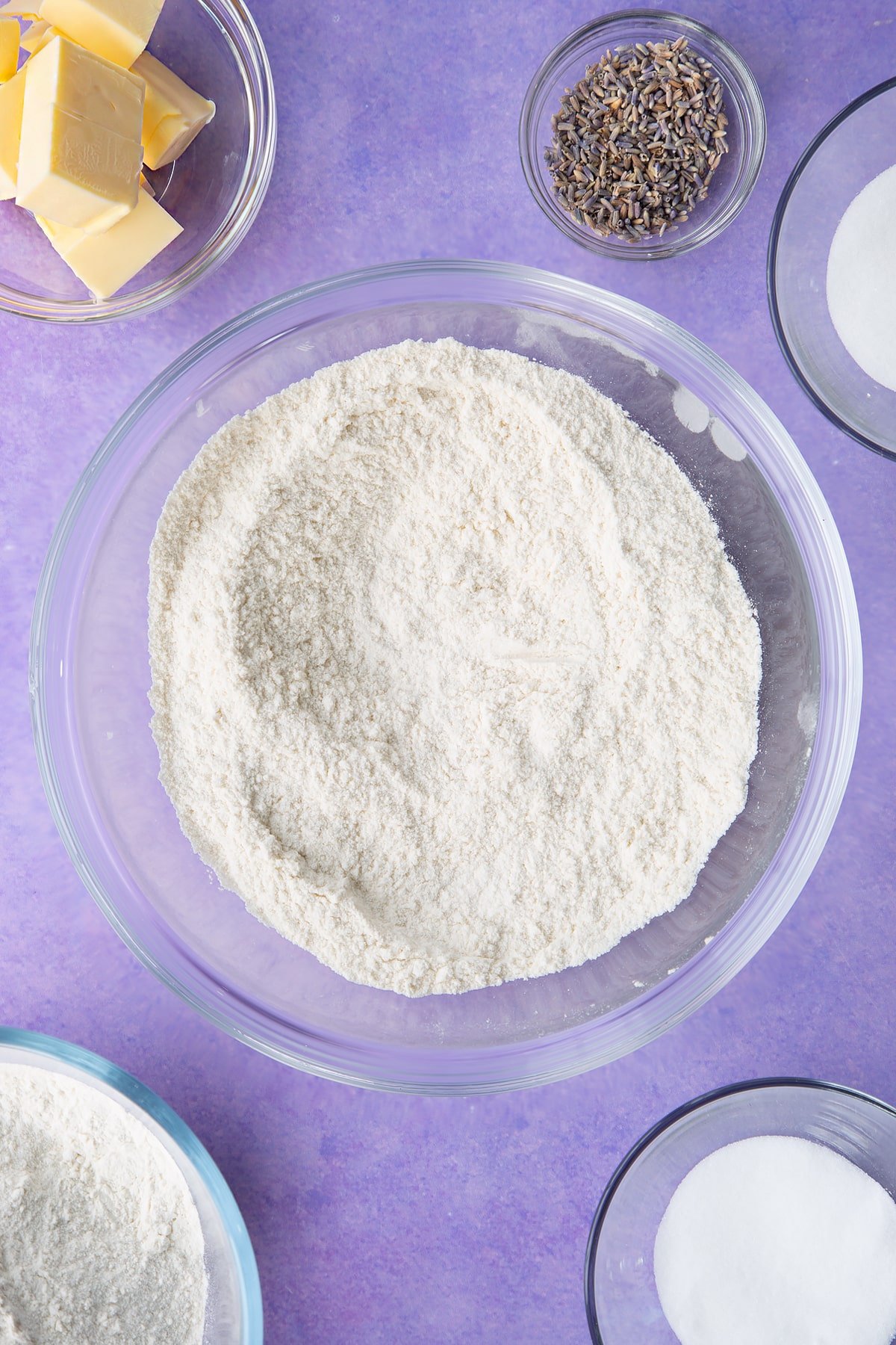 Flour and sugar mixed together in a bowl. Ingredients to make lavender shortbread cookies.