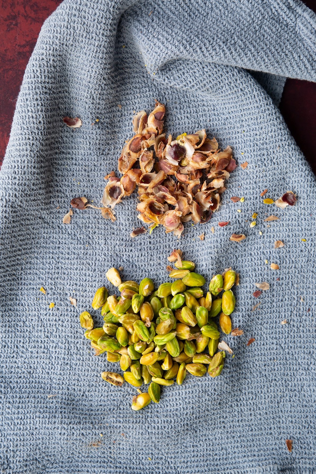 Overhead shot of the pistachios with the skins seperated.