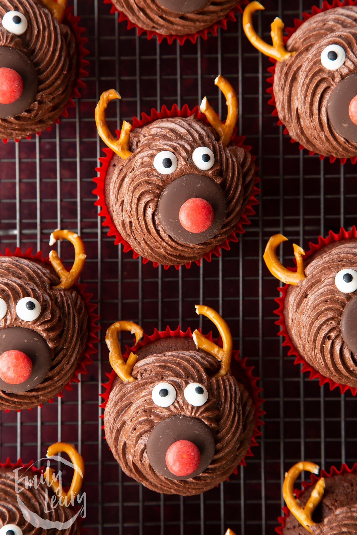 Reindeer cupcakes shown from above on a wire cooling rack.