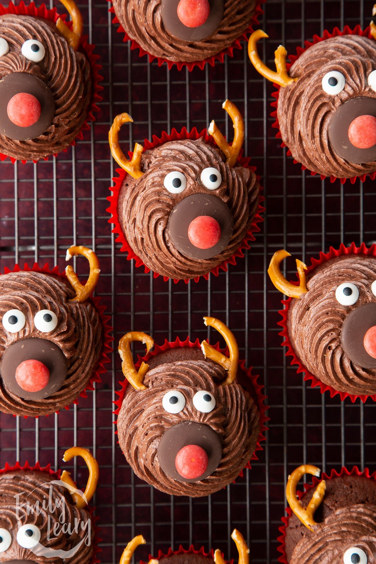 Reindeer cupcakes shown from above on a wire rack. 