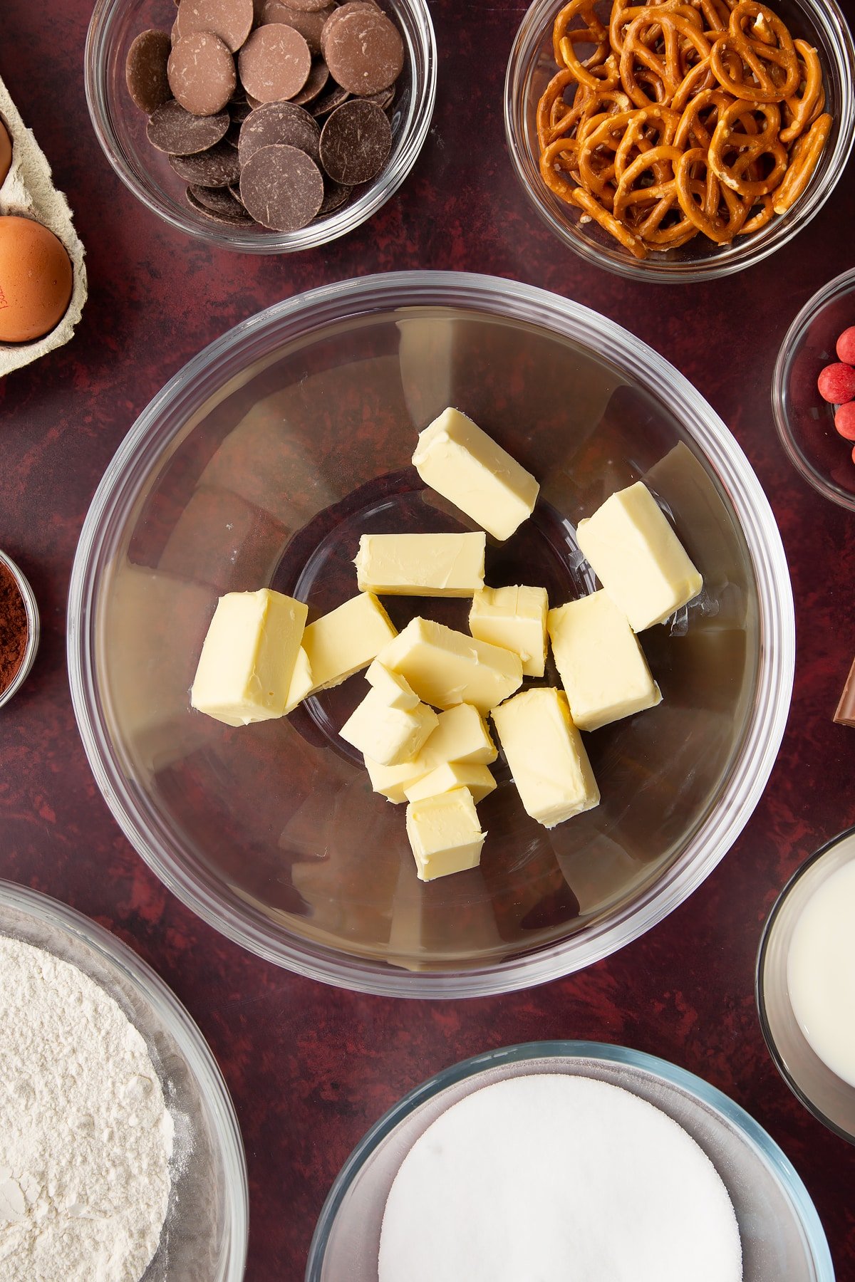 Softened butter in a mixing bowl. Ingredients to make reindeer cupcakes surround the bowl.