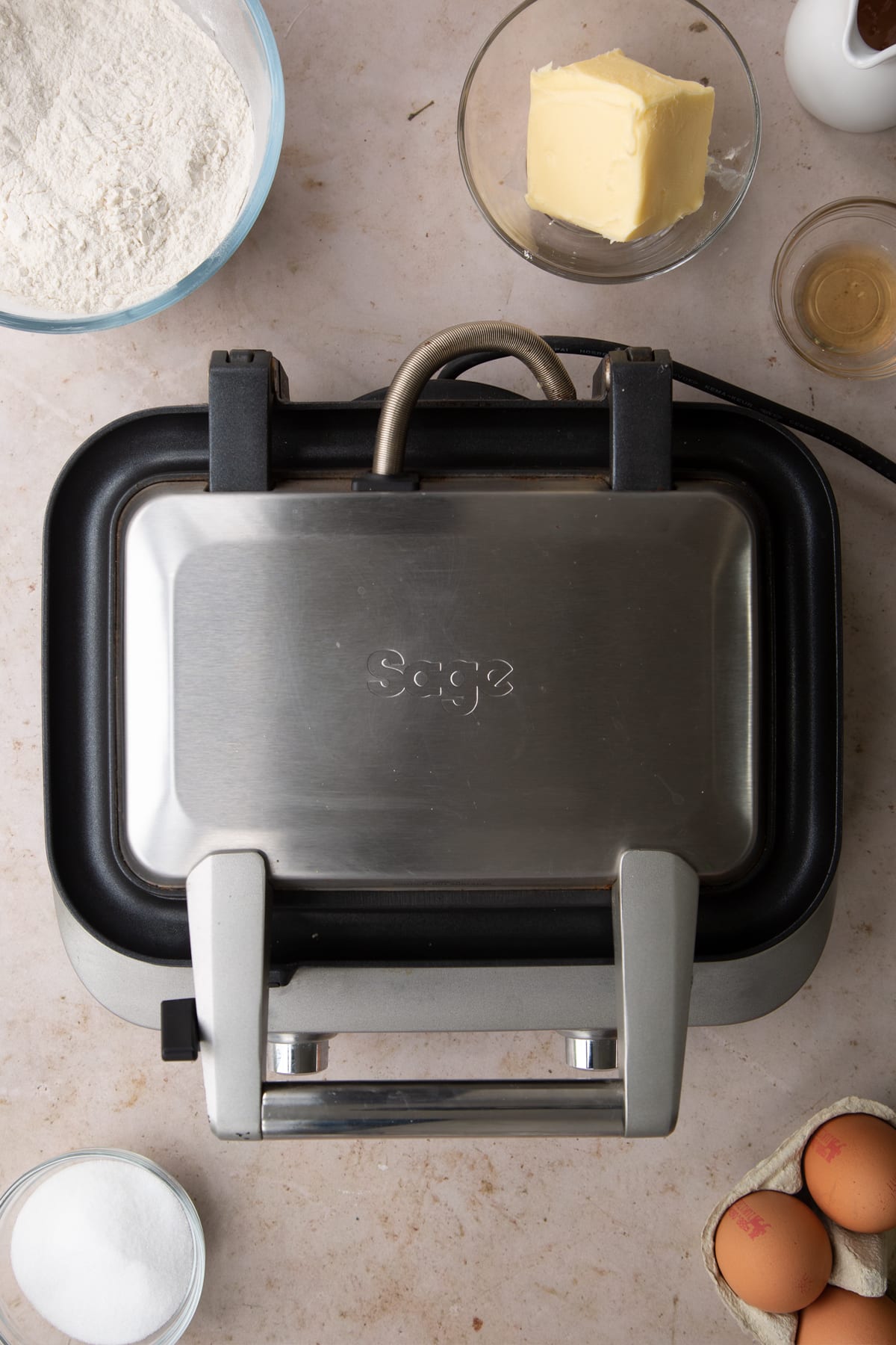 class sage smart waffle maker closed on a grey background.