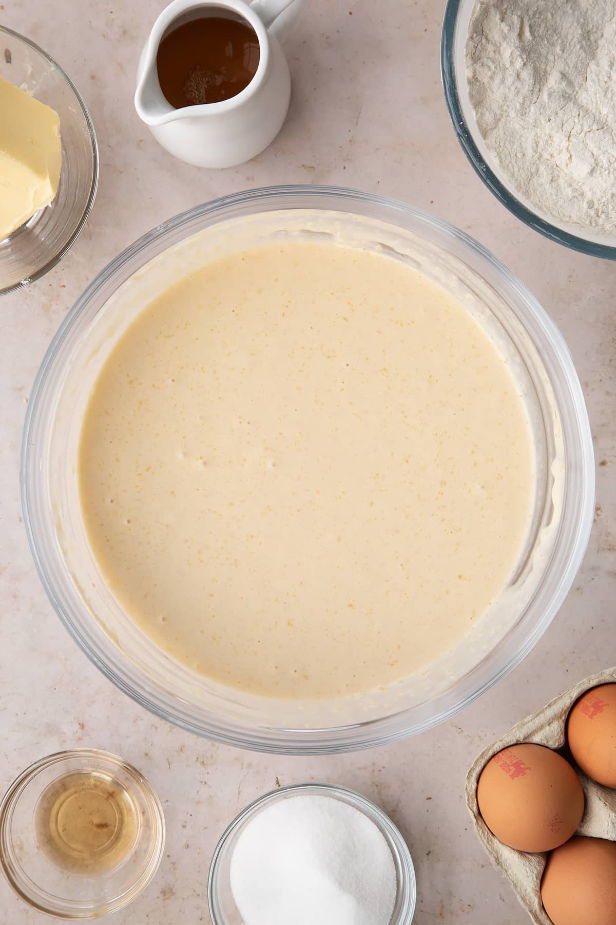 whisked dry and wet ingredients in a large clear bowl.