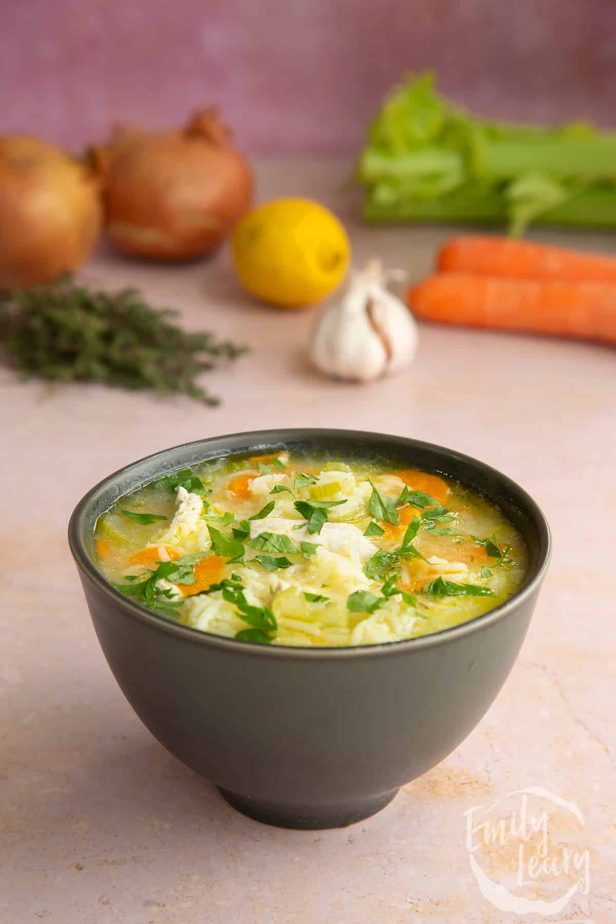 Close up shot of the finished turkey rice soup served in a black bowl.