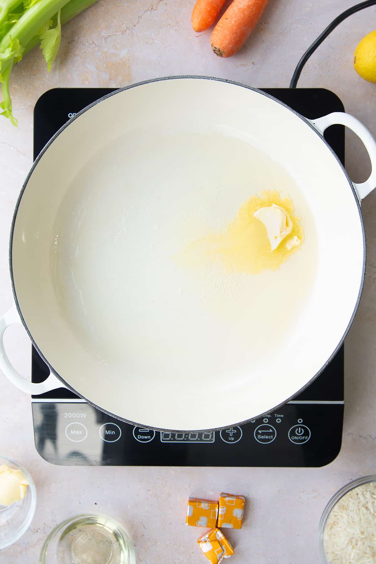 Overhead shot of butter melting in a pan.