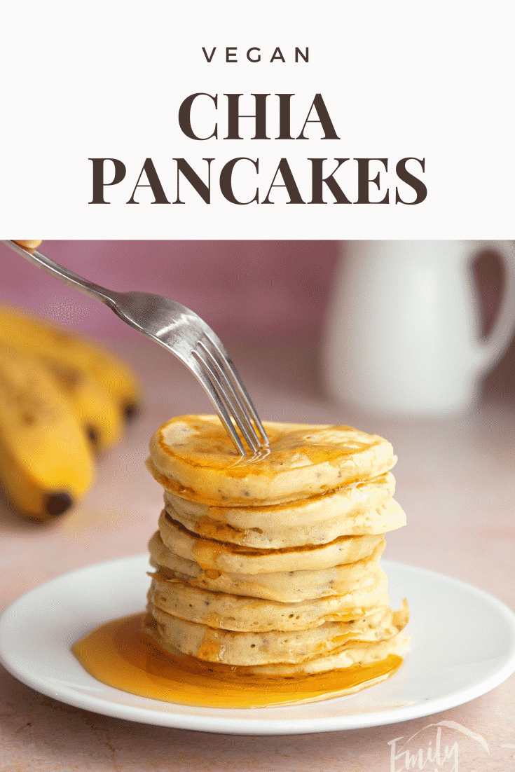 A stack of vegan chia pancakes on a small white plate, drizzled with golden syrup. A fork digs in. Caption reads: Vegan chia pancakes.