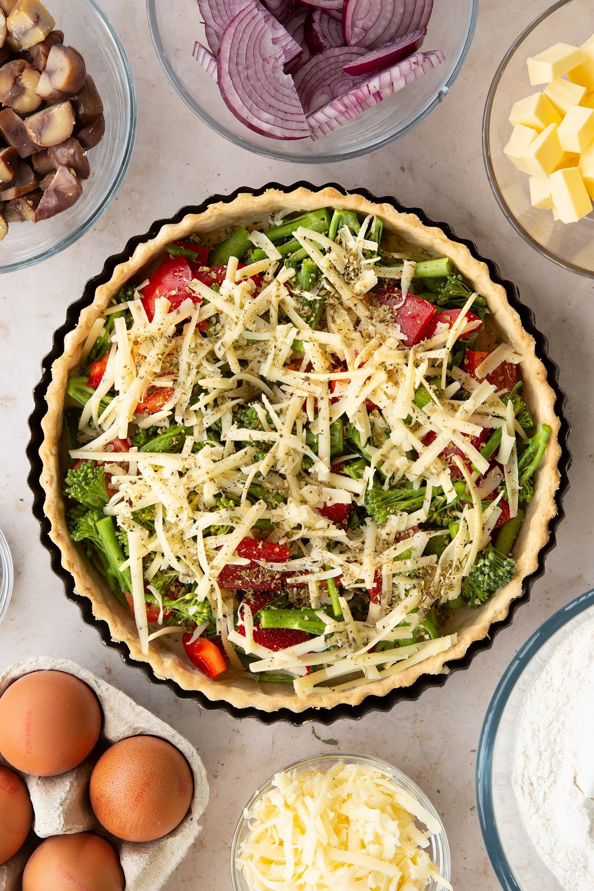 Overhead shot of the broccoli and pepper quiche with a sprinkling of cheese on top.