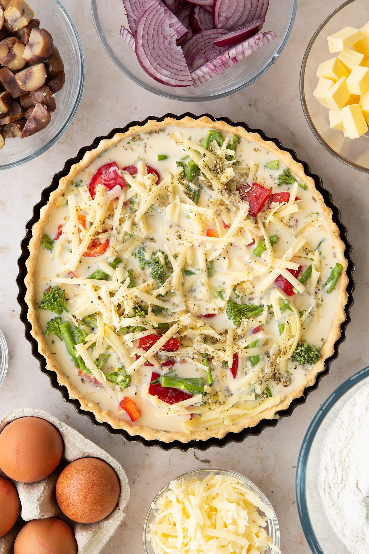 Overhead shot of the raw broccoli and pepper quiche 