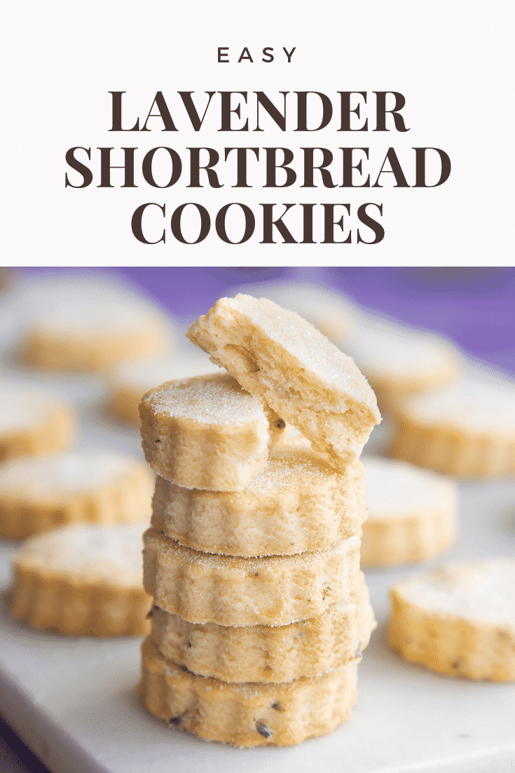 Lavender shortbread cookies stacked on a white marble board. One is broken in half. Caption reads: Easy lavender shortbread cookies.